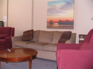 Shelter quiet area with a three seater couch and two single couch seats and a coffee table. 2012