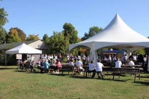 Event participants enjoying the picnic tables and tent at the 2015 Ferguson Memorial Walk.