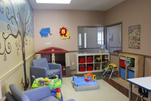 Children's play area in shelter with lots of toys and some seating areas.