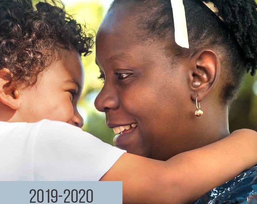 Cover page of Family Transition Place's Annual Report for 2019-2020. A mother holding her son looking in to his eyes smiling.