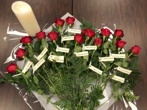 Fourteen red roses labelled with the names of the fourteen women killed in Montreal in 1989.
