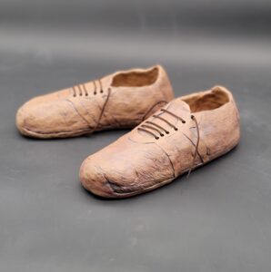 a pair of clay shoes sculpted by Ann Randeraad