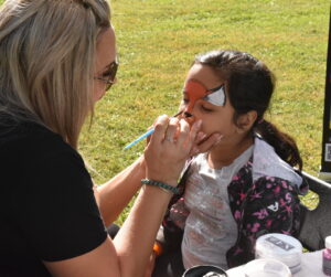 Fun Faces by Mel face painting table at Heidi's Walk for Hope 2023.