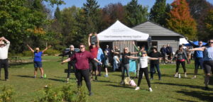Heidi's Walk for Hope September 2023 participants taking part in a pre-walk stretch.
