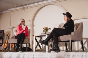 Serena Ryder speaking with Norah Kennedy on stage at 2024 International Women's Day Celebration Event