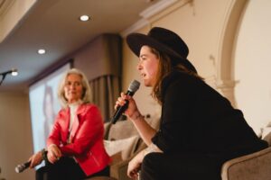 Serena Ryder speaking with Norah Kennedy on stage at 2024 International Women's Day Celebration Event