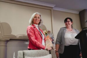 Sharyn Ayliffe presenting Norah Kennedy with flowers at 2024 International Women's Day Celebration Event